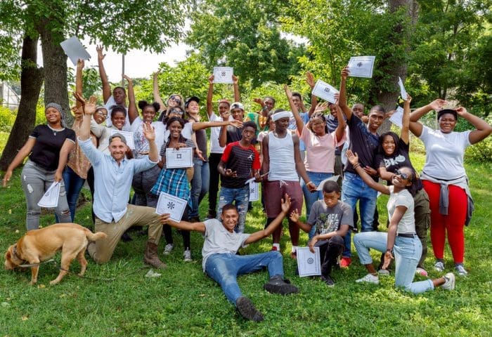 Group of young people smiling and holding certificates